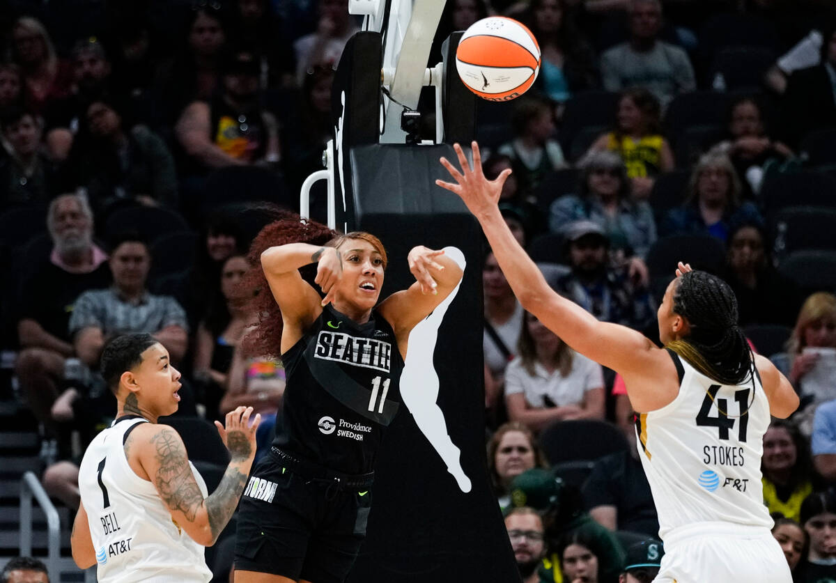 Seattle Storm guard Arella Guirantes (11) throws a pass over the defense from Las Vegas Aces gu ...