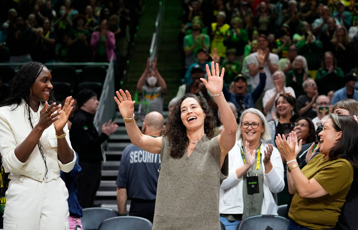 Former Seattle Storm player Sue Bird, center, acknowledges the crowd as former teammate and Sto ...