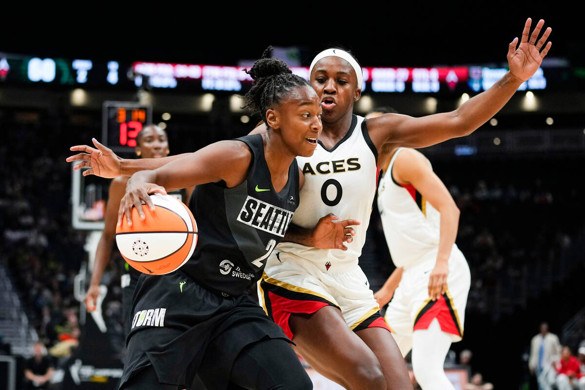 Seattle Storm guard Jewell Loyd (24) drives against Las Vegas Aces guard Jackie Young (0) durin ...