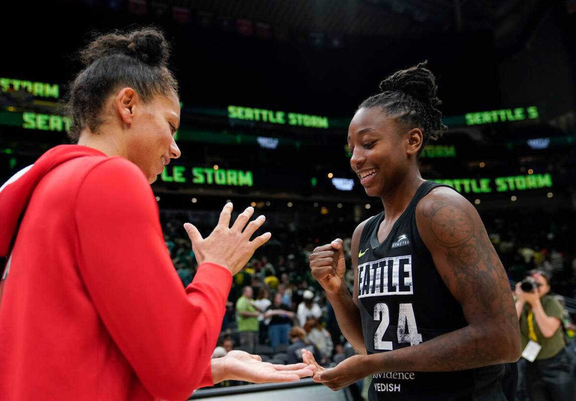 Las Vegas Aces forward Alysha Clark (7) plays rock, paper, scissors against Seattle Storm guard ...