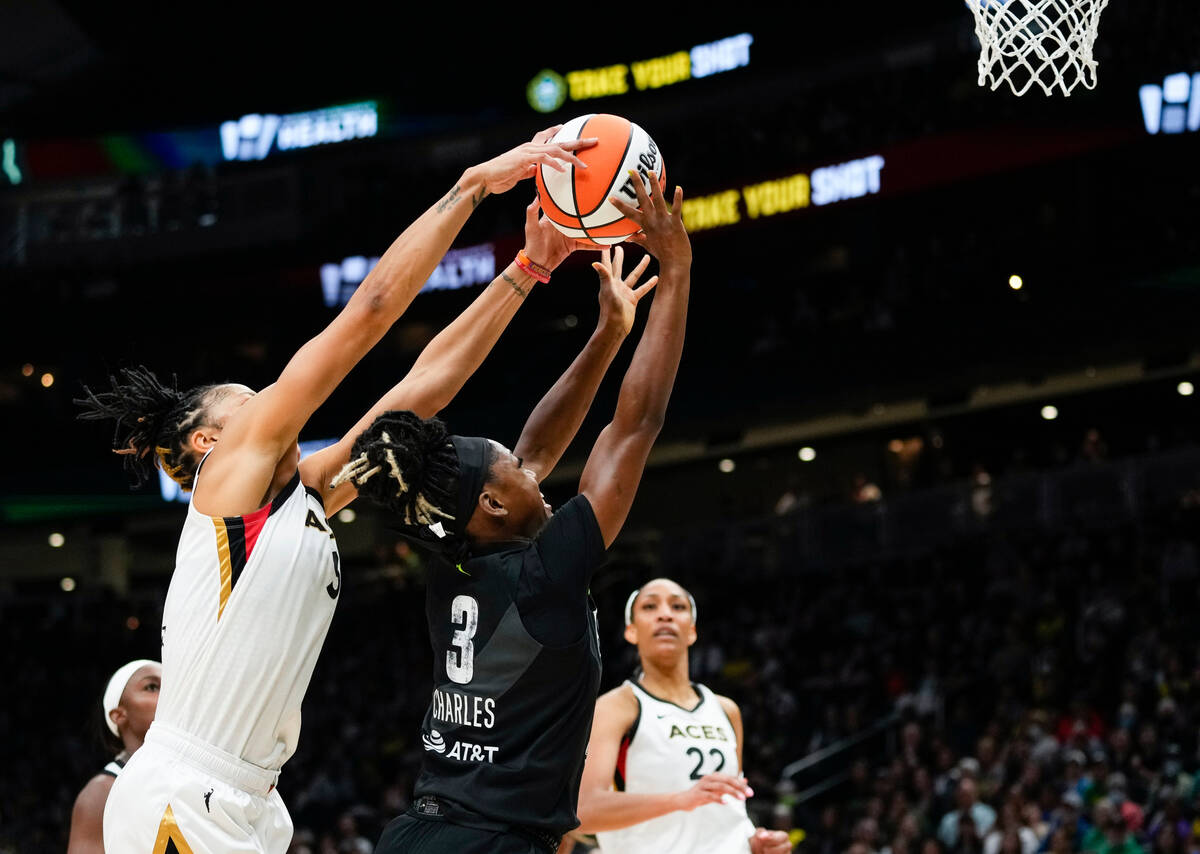 Las Vegas Aces forward Candace Parker, front left, blocks Seattle Storm guard Kaila Charles (3) ...