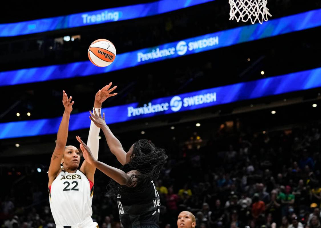 Las Vegas Aces forward A'ja Wilson (22) shoots over Seattle Storm center Ezi Magbegor (13) duri ...