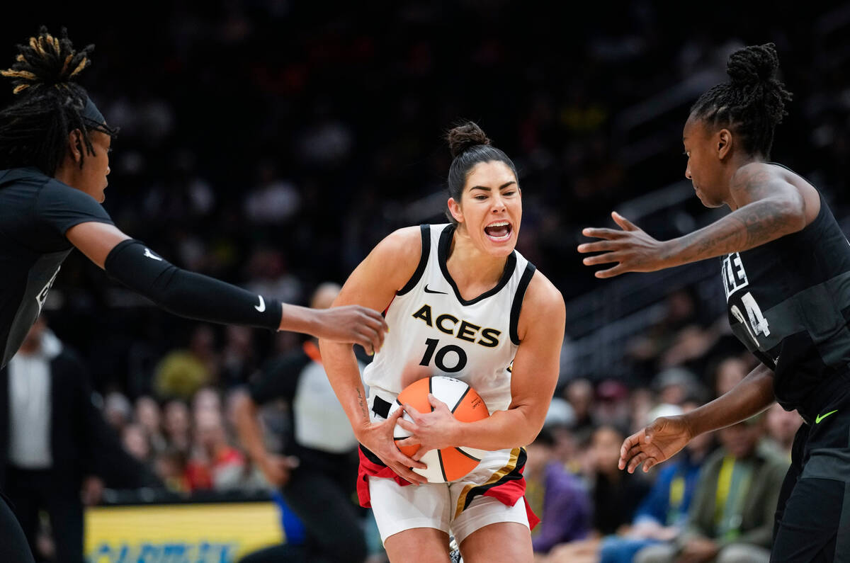 Las Vegas Aces guard Kelsey Plum (10) pushes through the defense of Seattle Storm guards Jordan ...