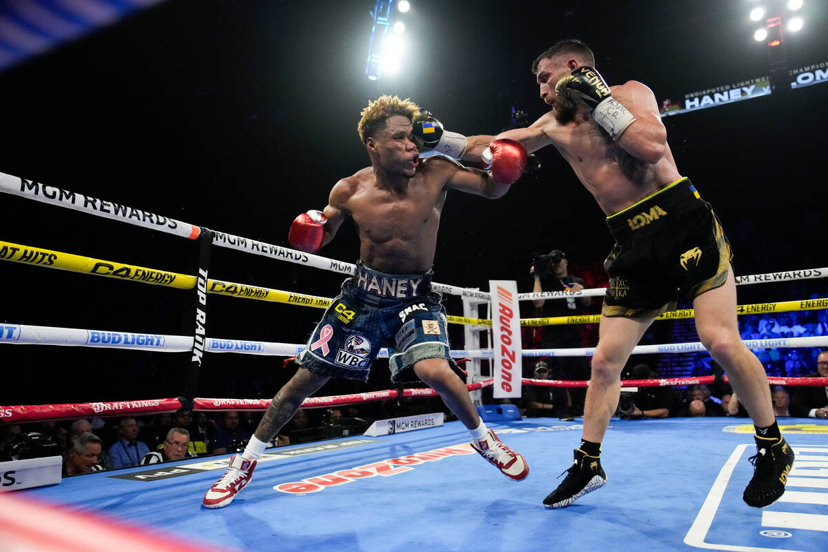 Devin Haney, left, fights Vasiliy Lomachenko in an undisputed lightweight championship boxing m ...
