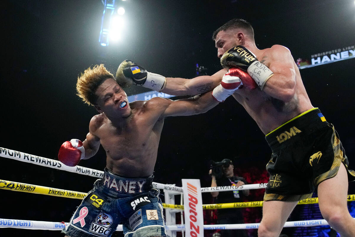 Devin Haney, left, fights Vasiliy Lomachenko in an undisputed lightweight championship boxing m ...