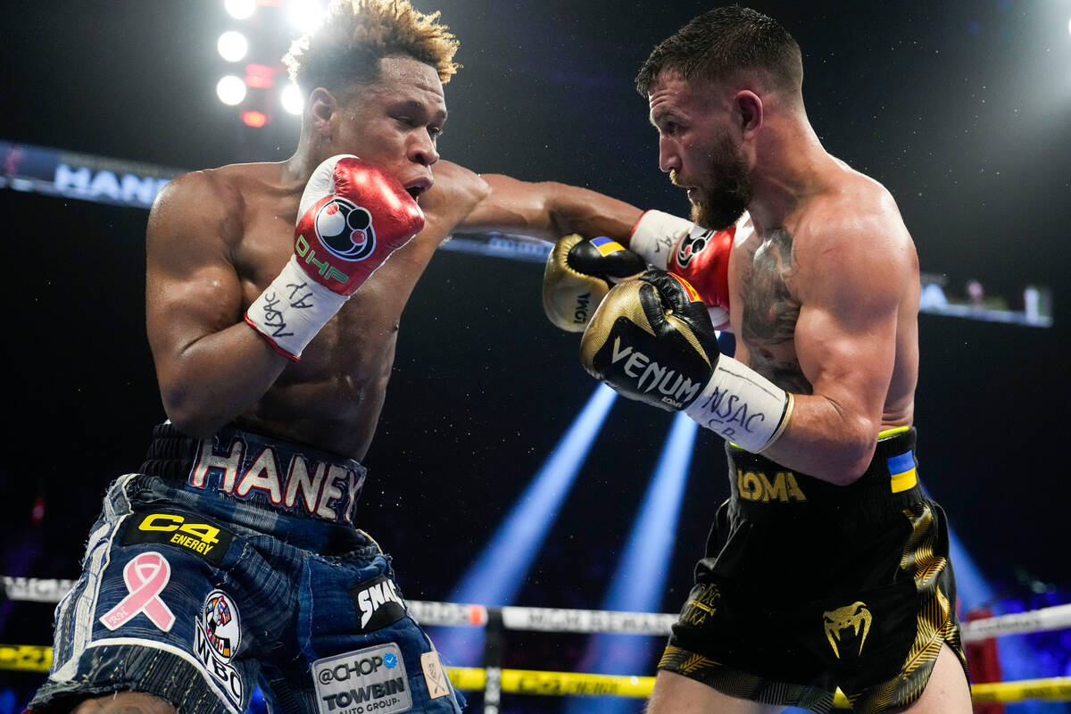 Devin Haney, left, fights Vasiliy Lomachenko in an undisputed lightweight championship boxing m ...