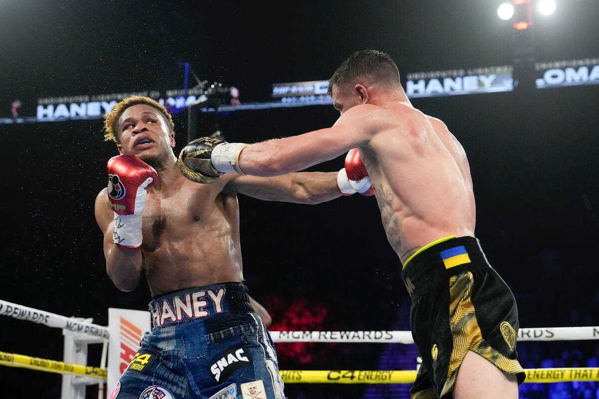 Devin Haney, left, fights Vasiliy Lomachenko in an undisputed lightweight championship boxing m ...