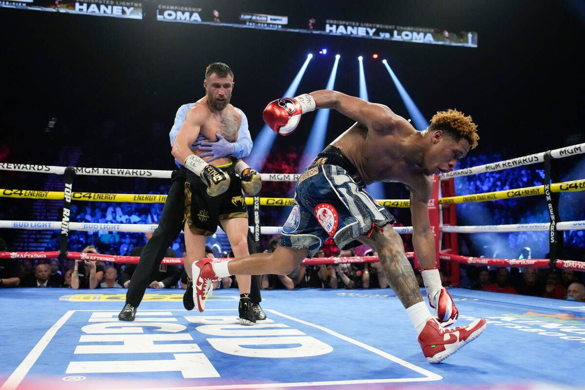 Devin Haney slips as he fights Vasiliy Lomachenko in an undisputed lightweight championship box ...