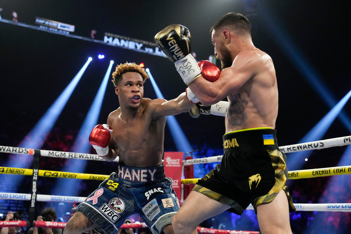 Devin Haney, left, fights Vasiliy Lomachenko in an undisputed lightweight championship boxing m ...