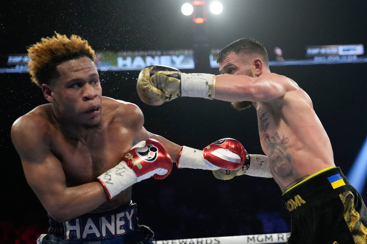 Devin Haney, left, fights Vasiliy Lomachenko in an undisputed lightweight championship boxing m ...
