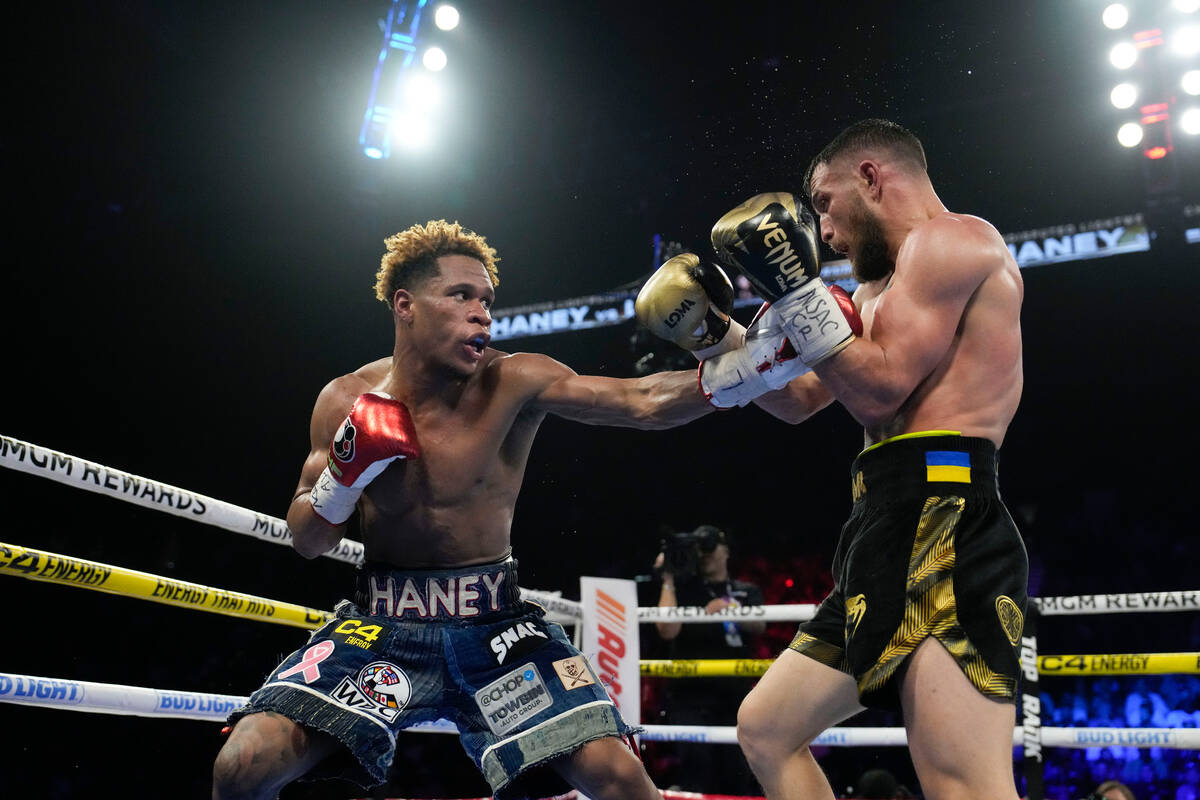Devin Haney, left, fights Vasiliy Lomachenko in an undisputed lightweight championship boxing m ...