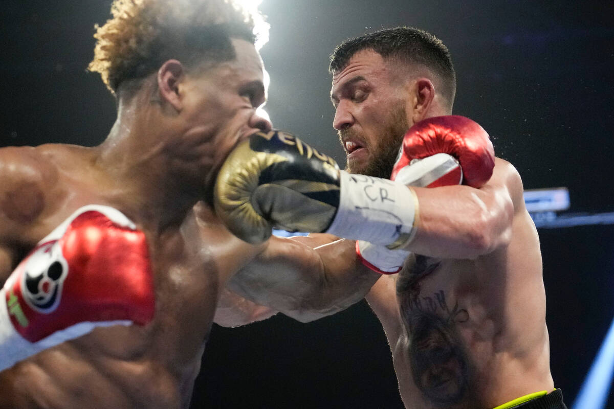 Devin Haney, left, fights Vasiliy Lomachenko in an undisputed lightweight championship boxing m ...
