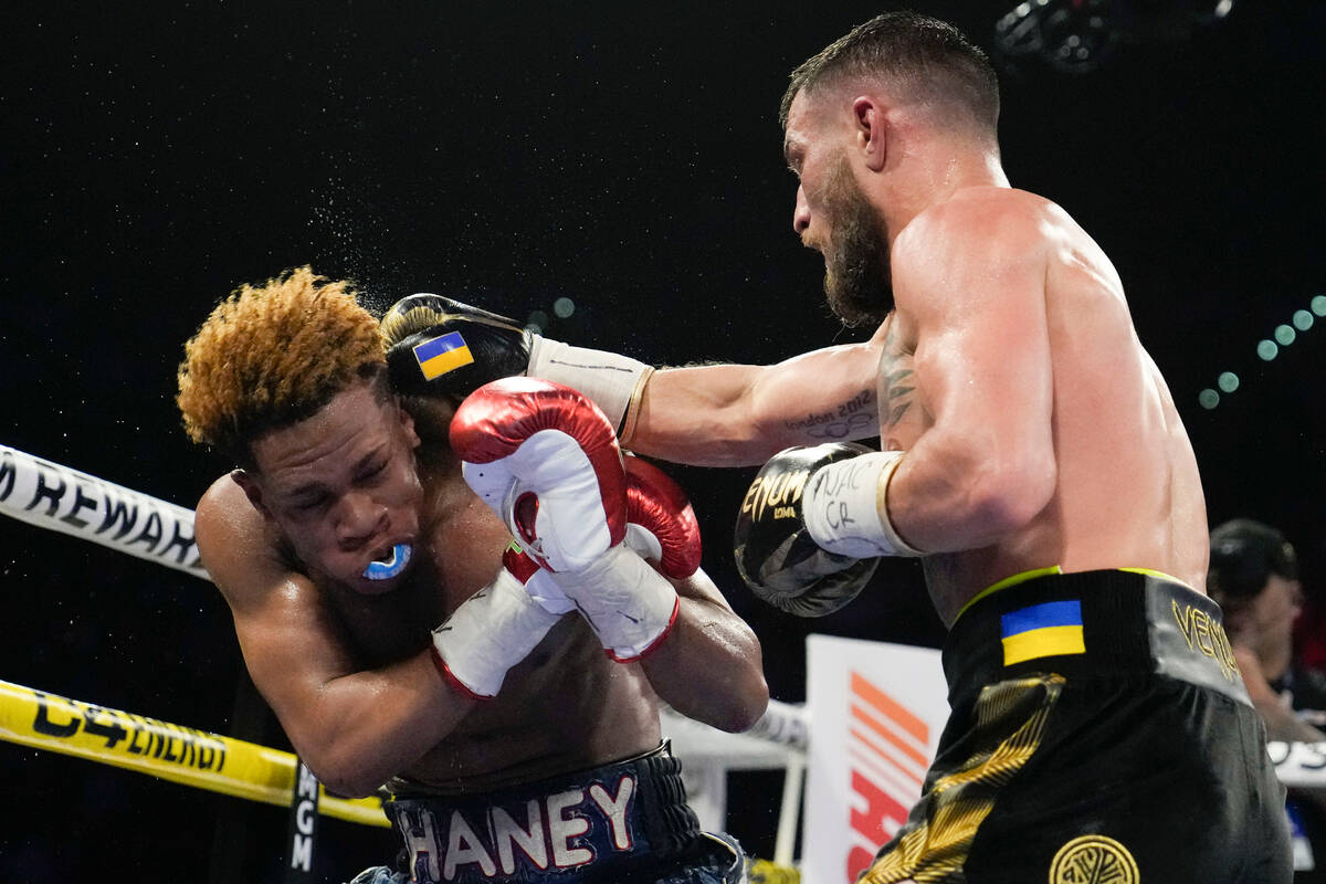 Devin Haney, left, fights Vasiliy Lomachenko in an undisputed lightweight championship boxing m ...