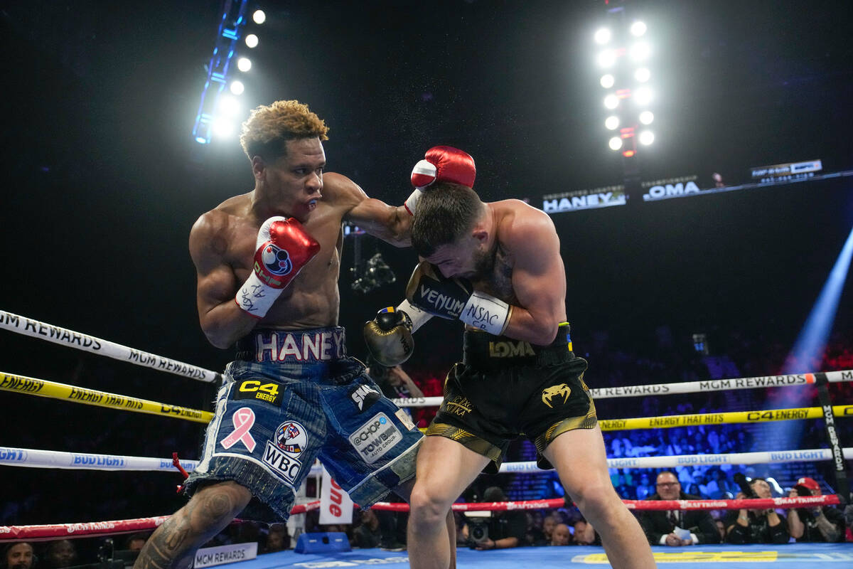 Devin Haney, left, fights Vasiliy Lomachenko in an undisputed lightweight championship boxing m ...