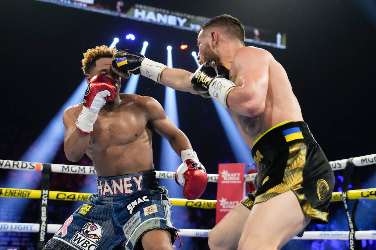 Devin Haney, left, fights Vasiliy Lomachenko in an undisputed lightweight championship boxing m ...