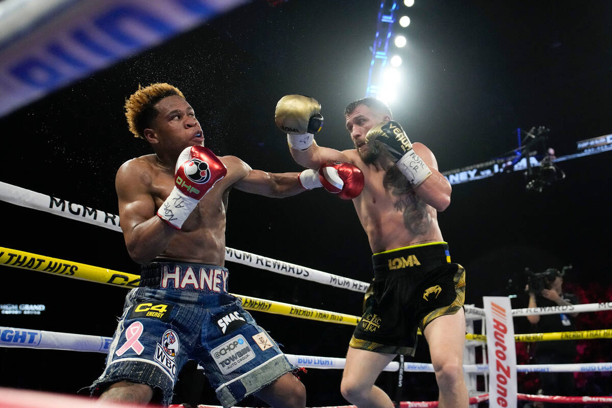 Devin Haney, left, fights Vasiliy Lomachenko in an undisputed lightweight championship boxing m ...