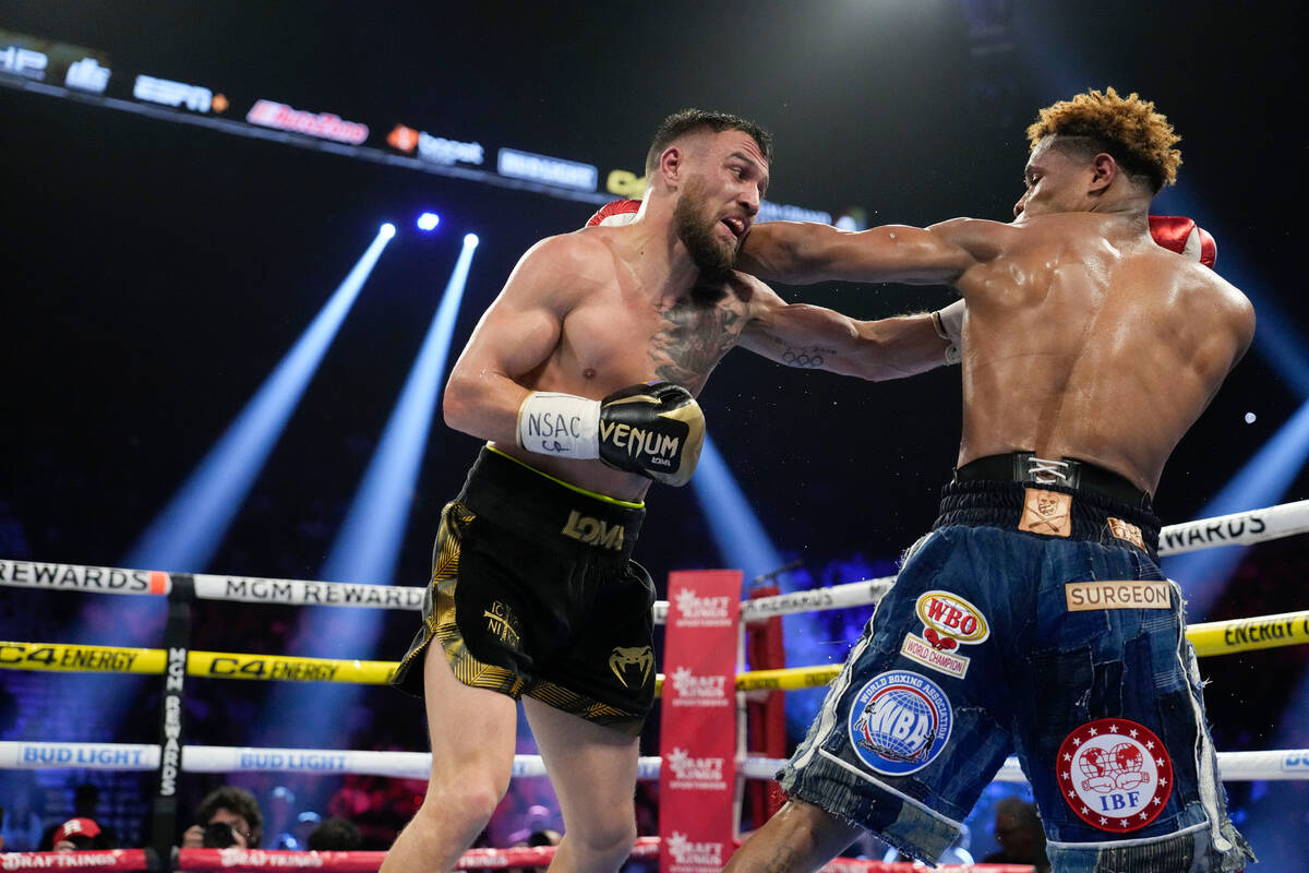Devin Haney, right, fights Vasiliy Lomachenko in an undisputed lightweight championship boxing ...