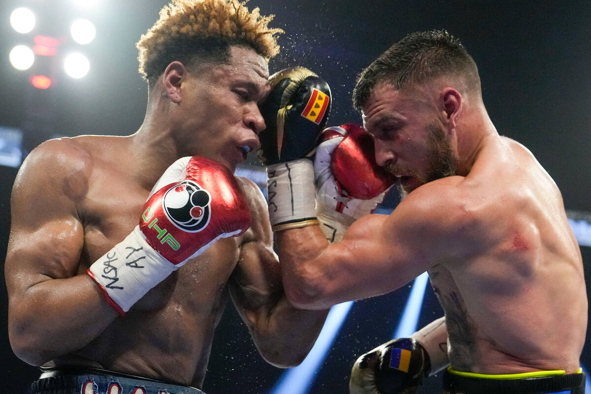Devin Haney, left, fights Vasiliy Lomachenko in an undisputed lightweight championship boxing m ...
