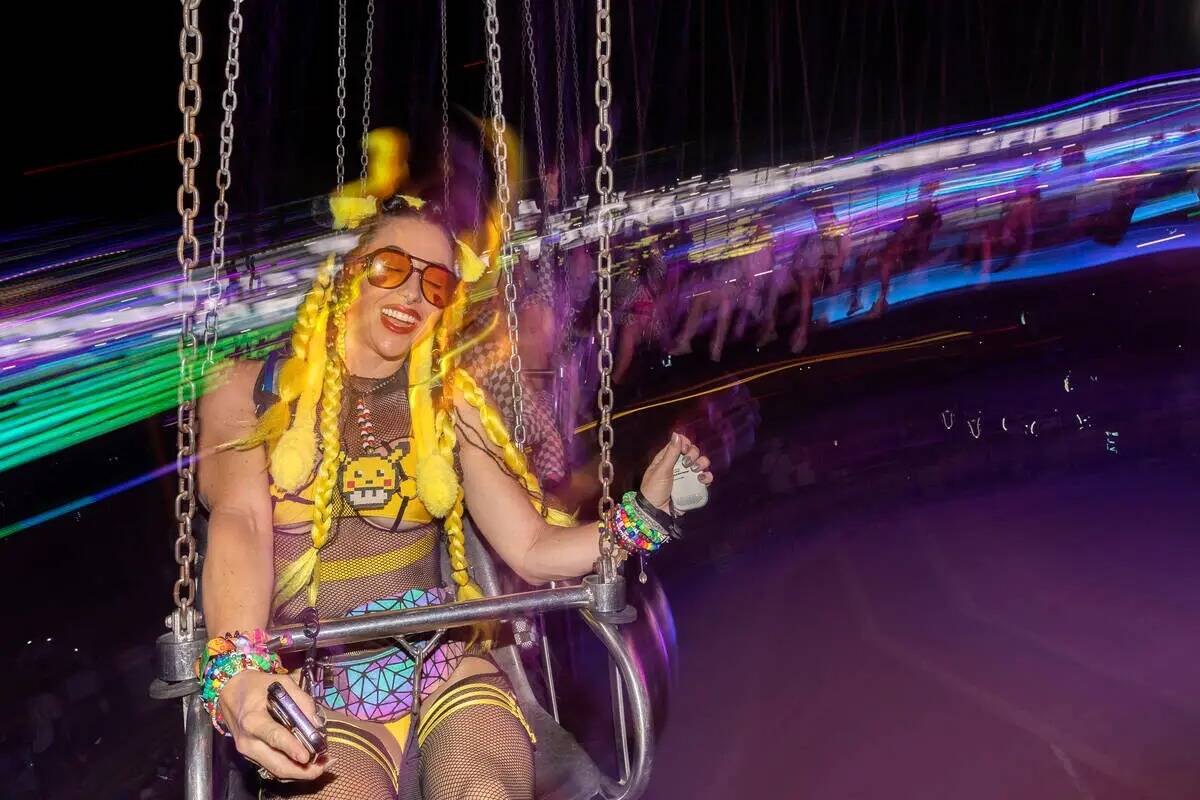 Jess Olson of San Diego rides the swings during the second day of the Electric Daisy Carnival e ...