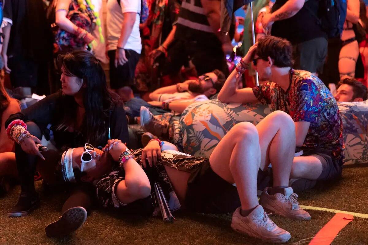 Attendees rest during the second day of the Electric Daisy Carnival electronic music festival o ...