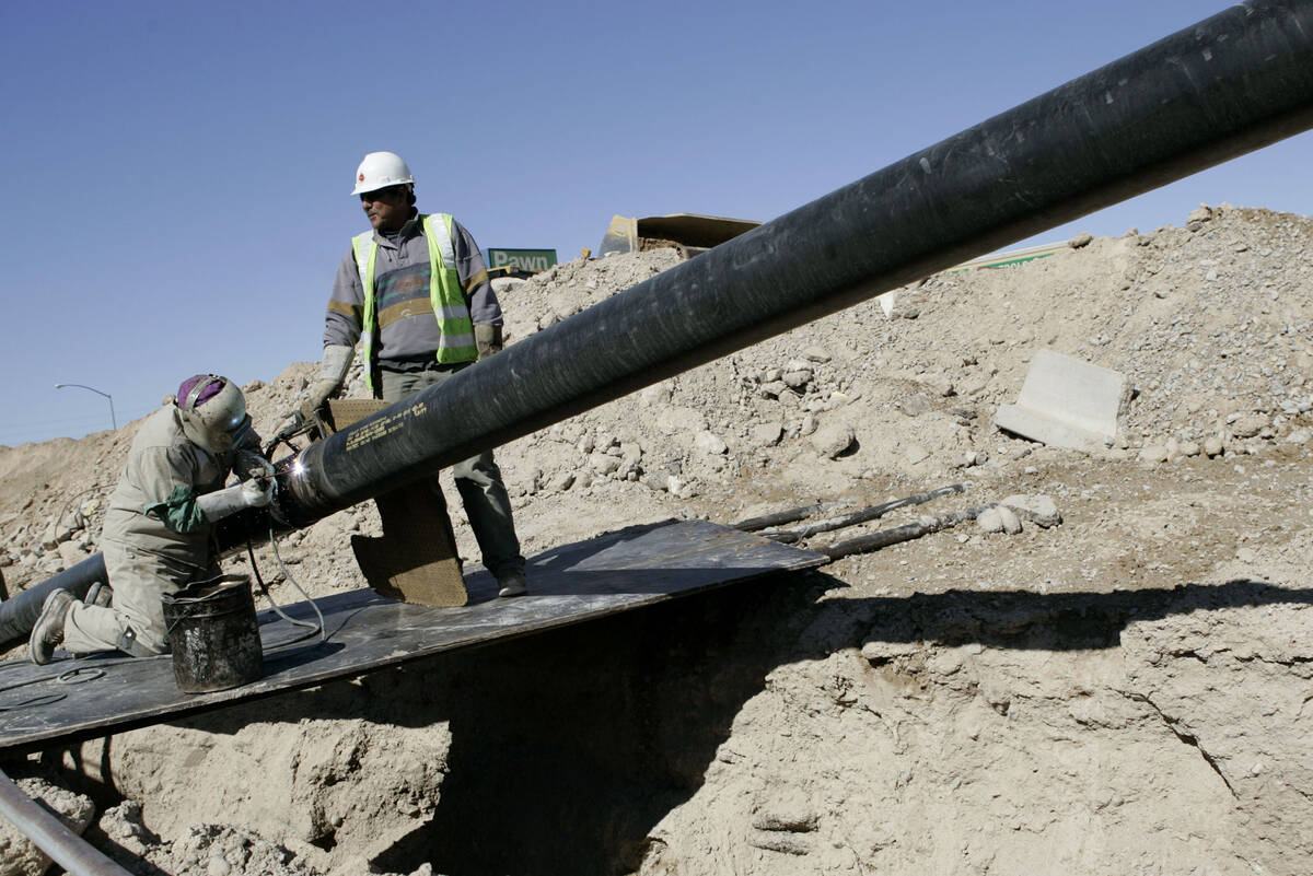 FILE - Welders contracted with Southwest Gas Corp. work on a natural gas pipeline in North Las ...