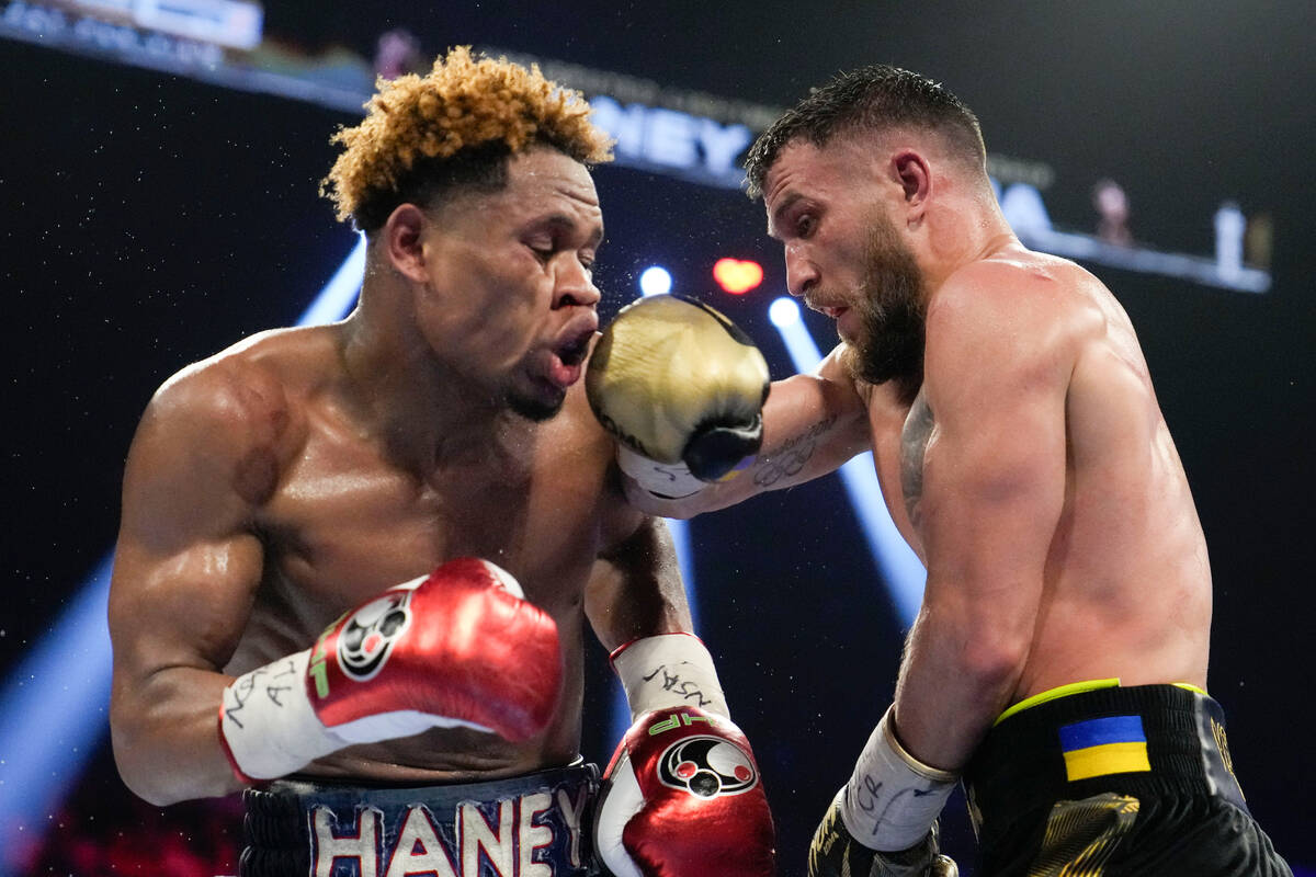 Devin Haney, left, fights Vasiliy Lomachenko in an undisputed lightweight championship boxing m ...