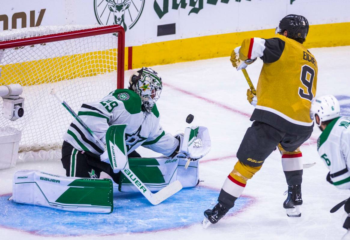 Dallas Stars goaltender Jake Oettinger (29) barely deflects a shot away by Golden Knights cente ...