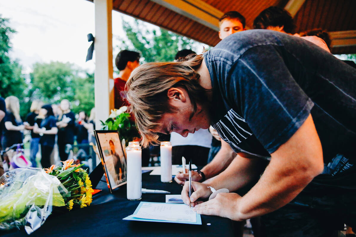 Ryan Jones signs a card at a vigil for 17-year-old Donavyn Propst on Sunday, May 21, 2023, in L ...