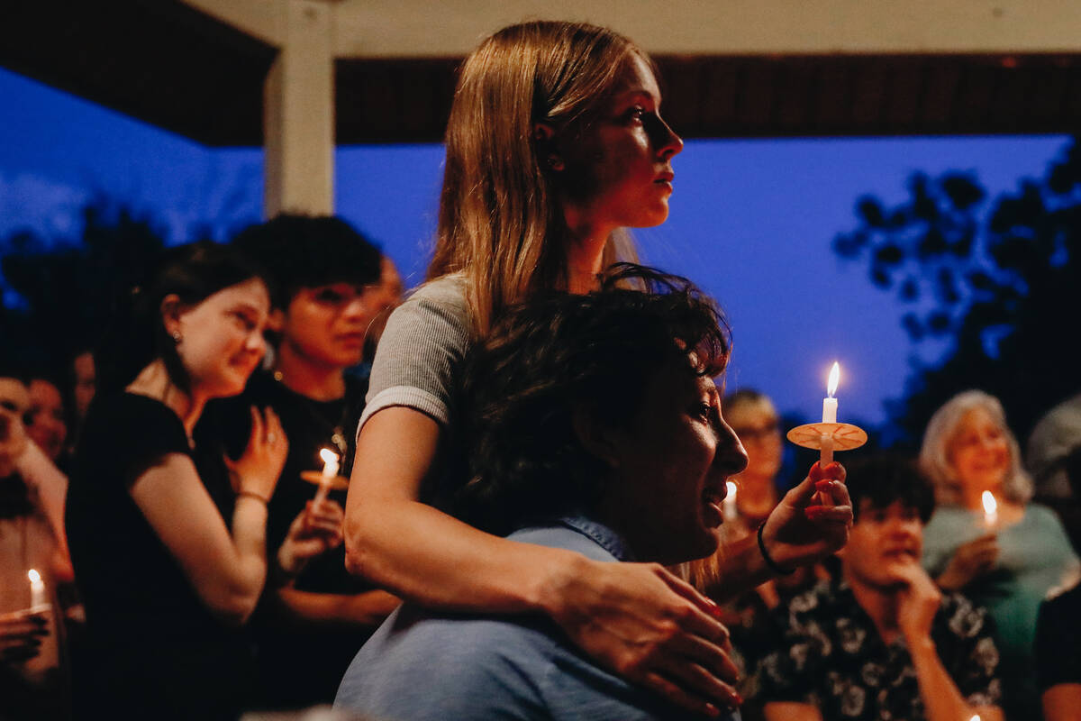 Friends of Donavyn Propst listen to his family speak about his memory at a vigil for the Faith ...