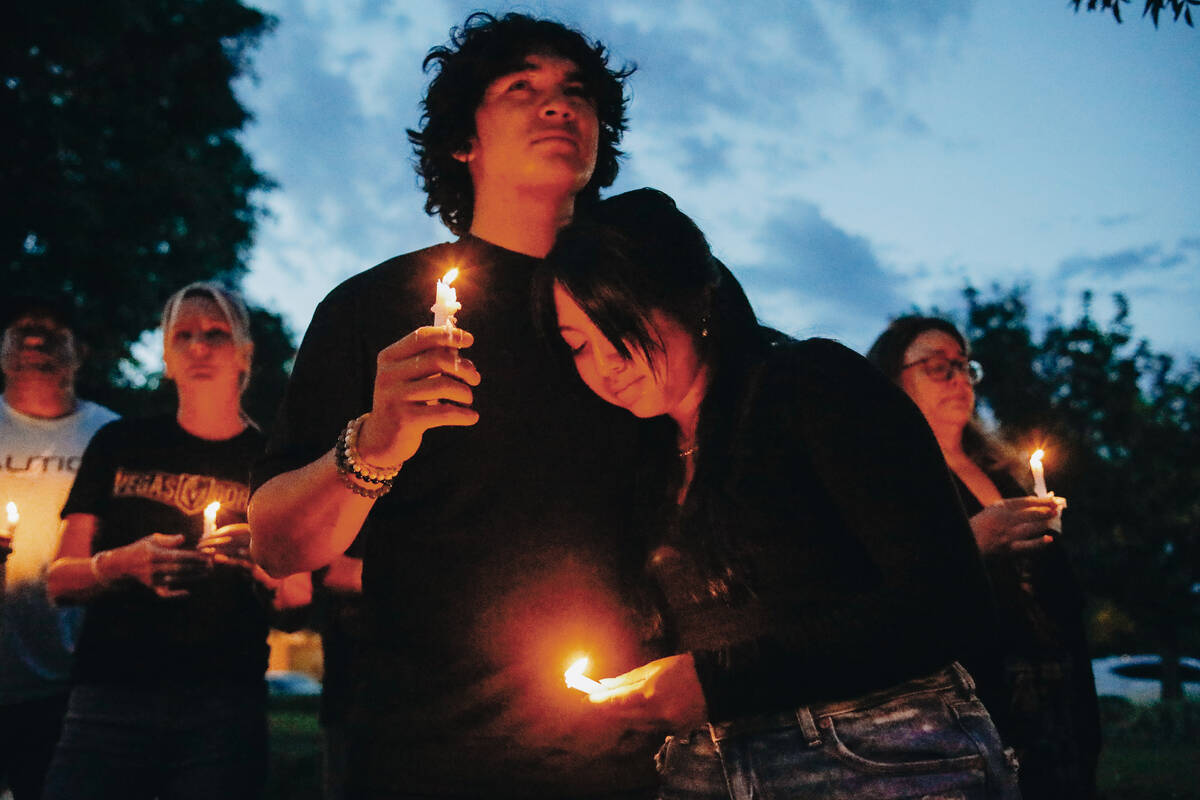 Mourners hold candles in memory of Donavyn Propst at a vigil for the 17-year-old on Sunday, May ...