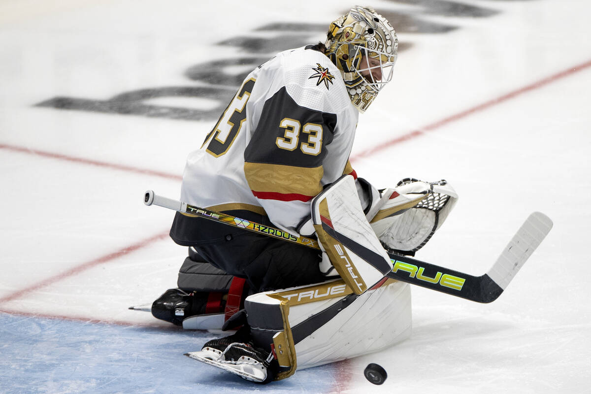 Golden Knights goaltender Adin Hill (33) saves the puck during the first period in Game 3 of th ...