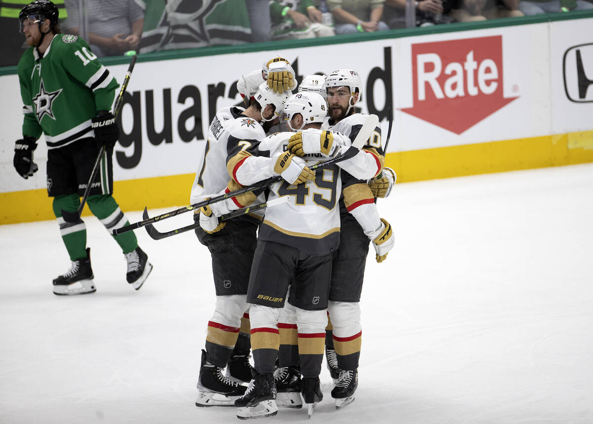 The Golden Knights rally around center Ivan Barbashev (49) after he scored while Dallas Stars c ...