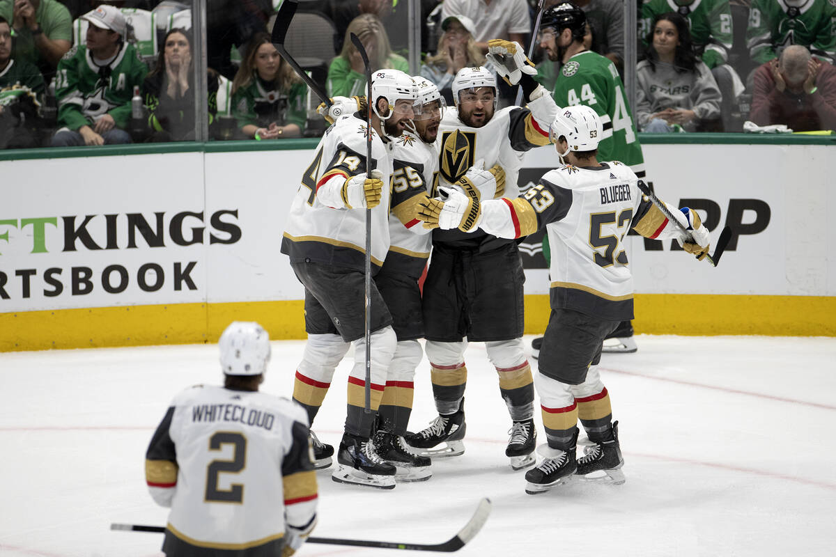 The Golden Knights surround left wing William Carrier (28) after he scored the third goal durin ...