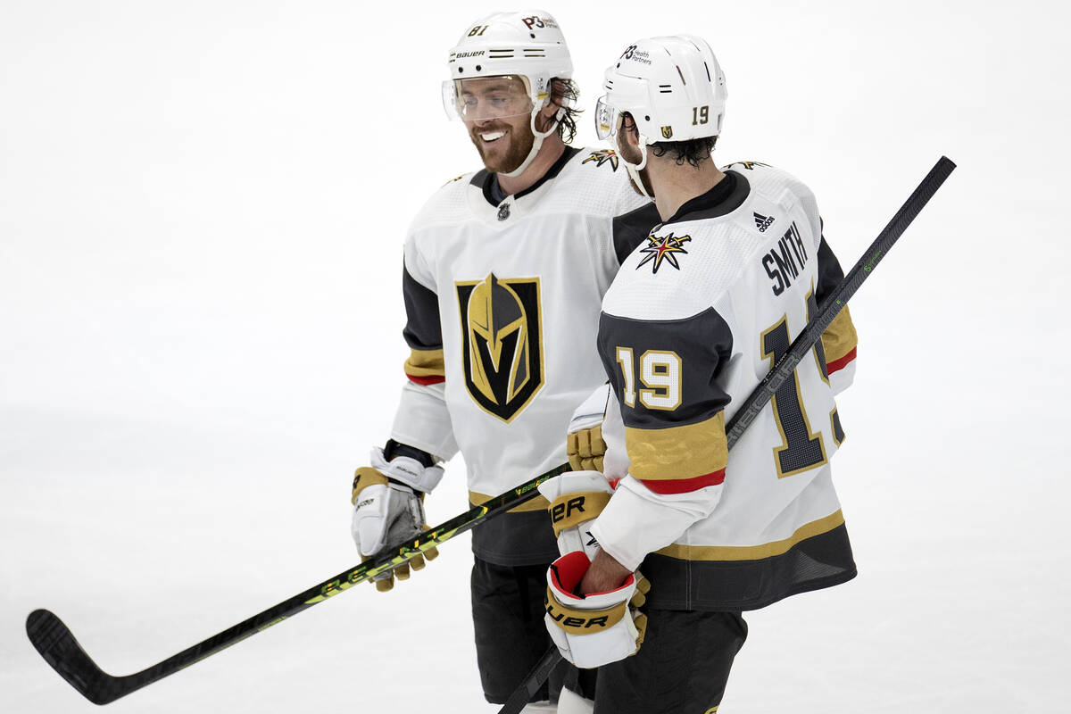 Golden Knights right wing Jonathan Marchessault (81) and right wing Reilly Smith (19) chat in b ...