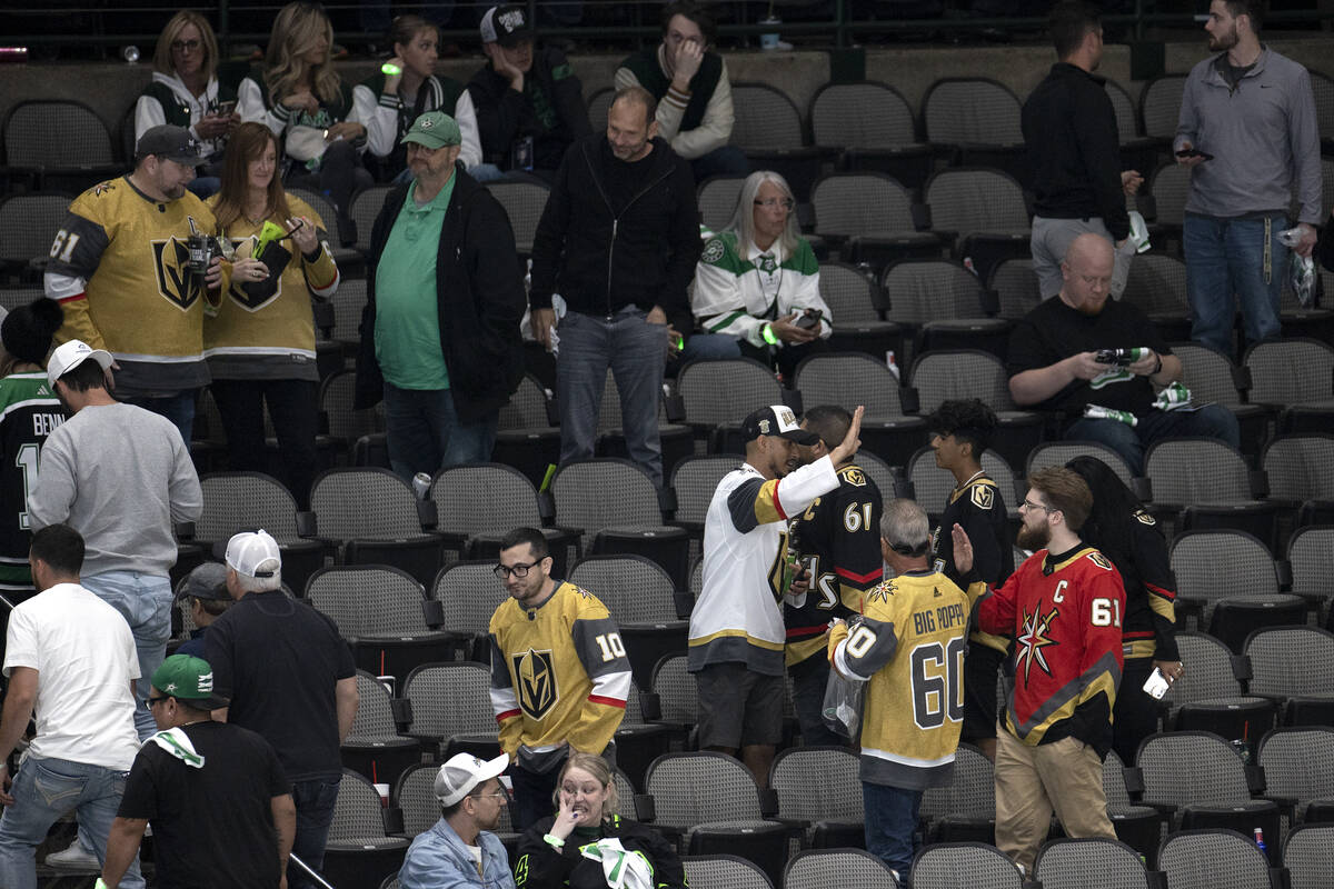 Golden Knights fans celebrate a win while Dallas Stars fan leave the arena after Game 3 of the ...