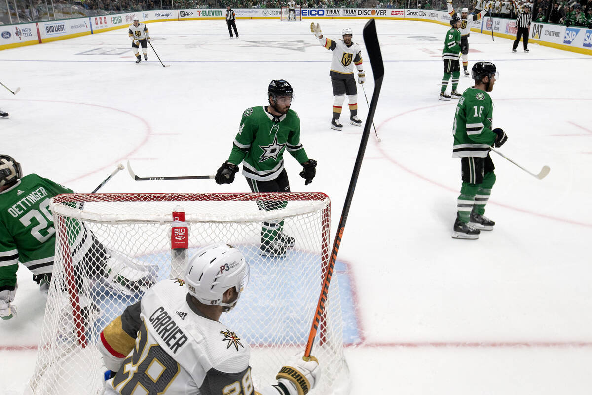 Golden Knights left wing William Carrier (28) skates to celebrate with right wing Keegan Kolesa ...