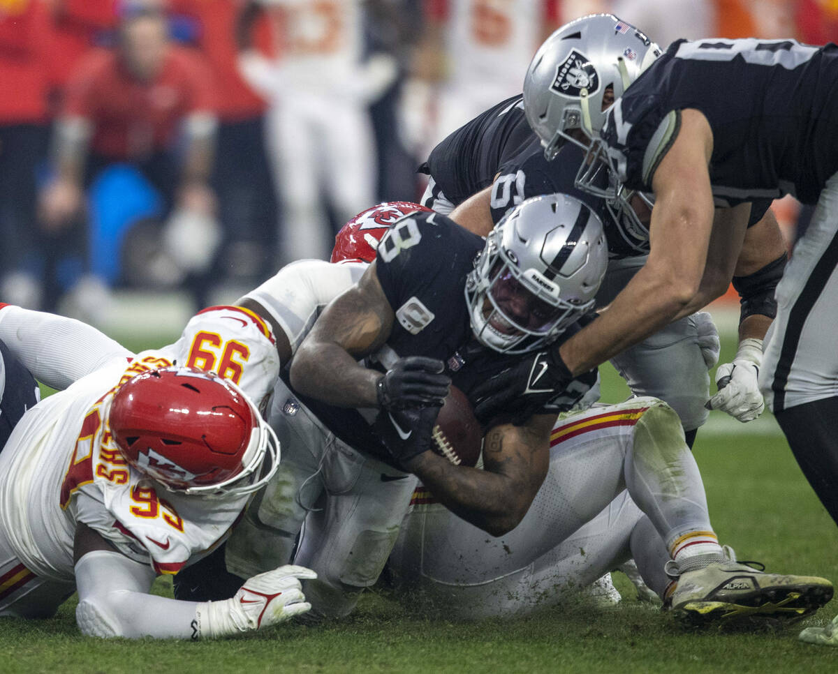 Raiders running back Josh Jacobs (28) is tackled by Kansas City Chiefs defensive tackle Khalen ...