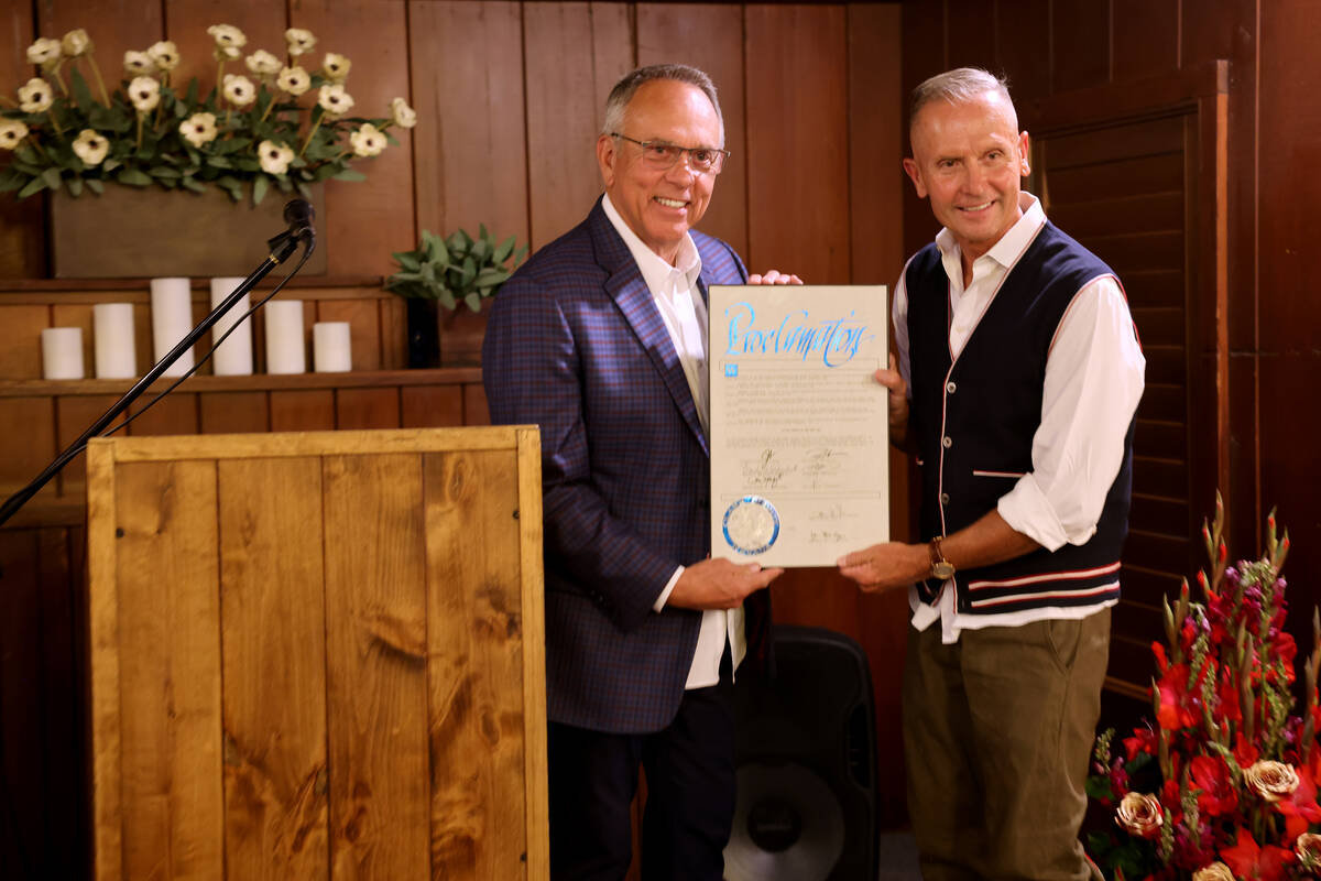 Owner Greg Smith, right, receives recognition from Clark County Commission Chairman Jim Gibson ...