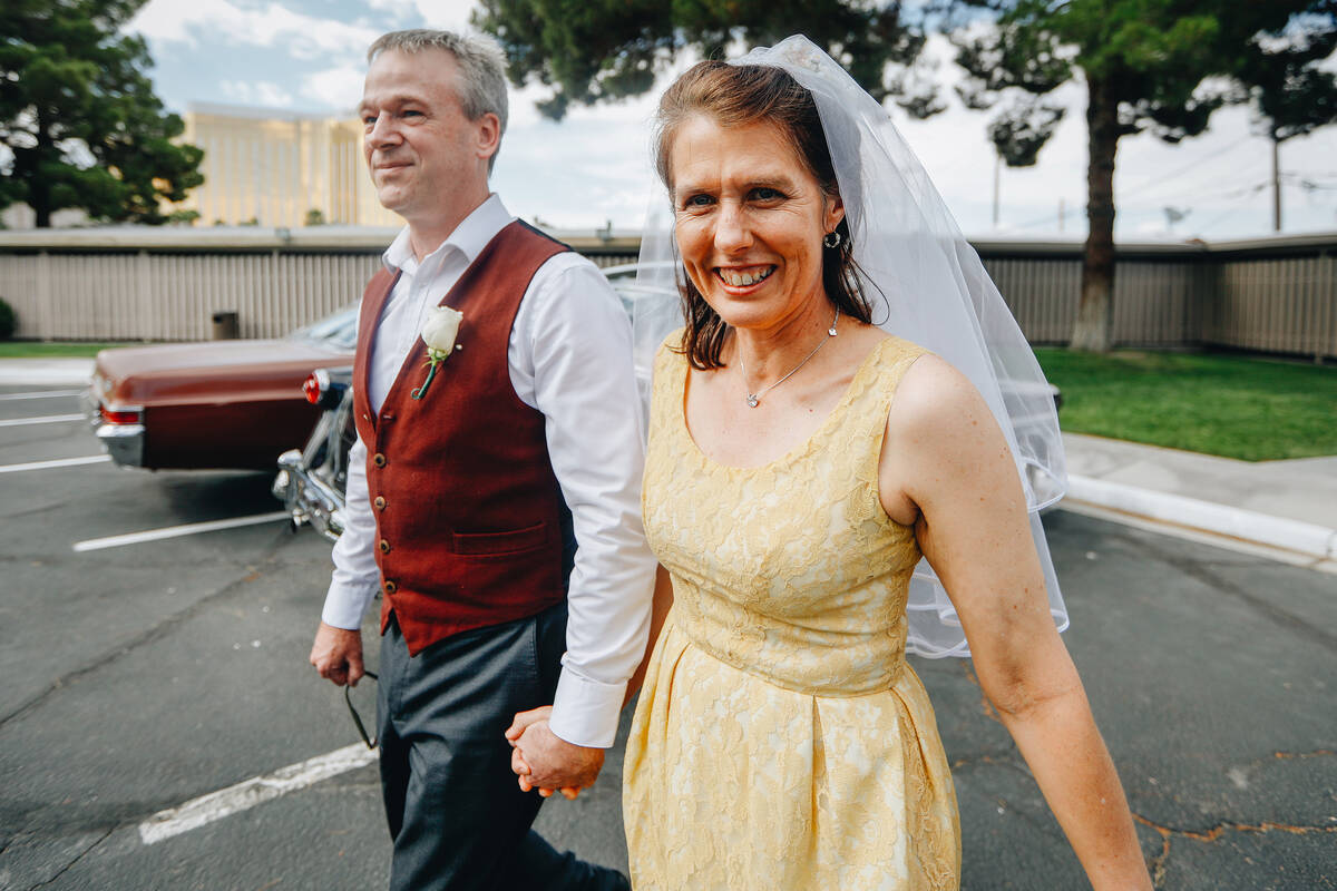 Tony Davey, left, holds hands with his wife Andrea Davey after renewing their vows together on ...