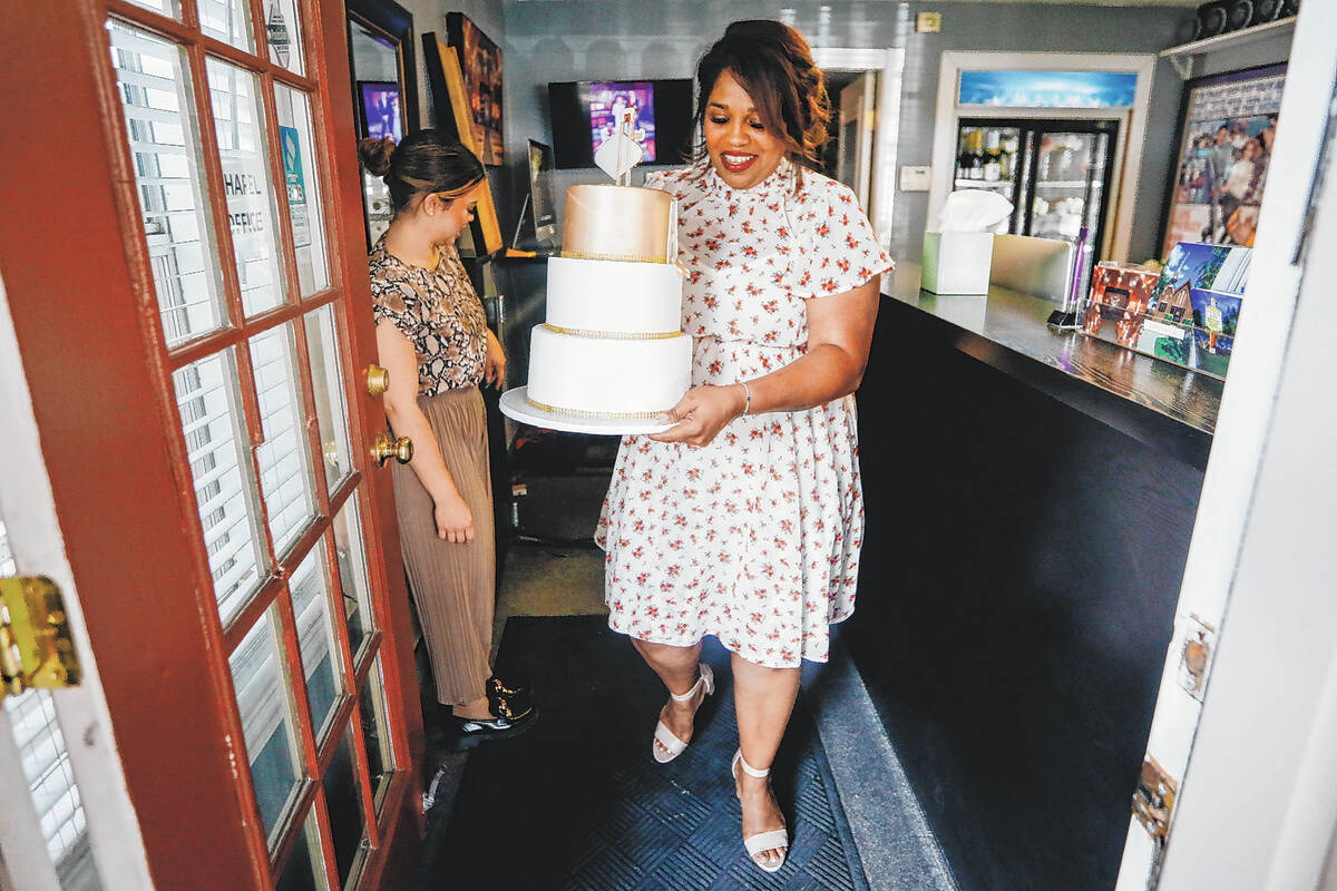 Yvette Smith carries a cake out to a celebration on Monday, May 22, 2023, at the Little Chapel ...