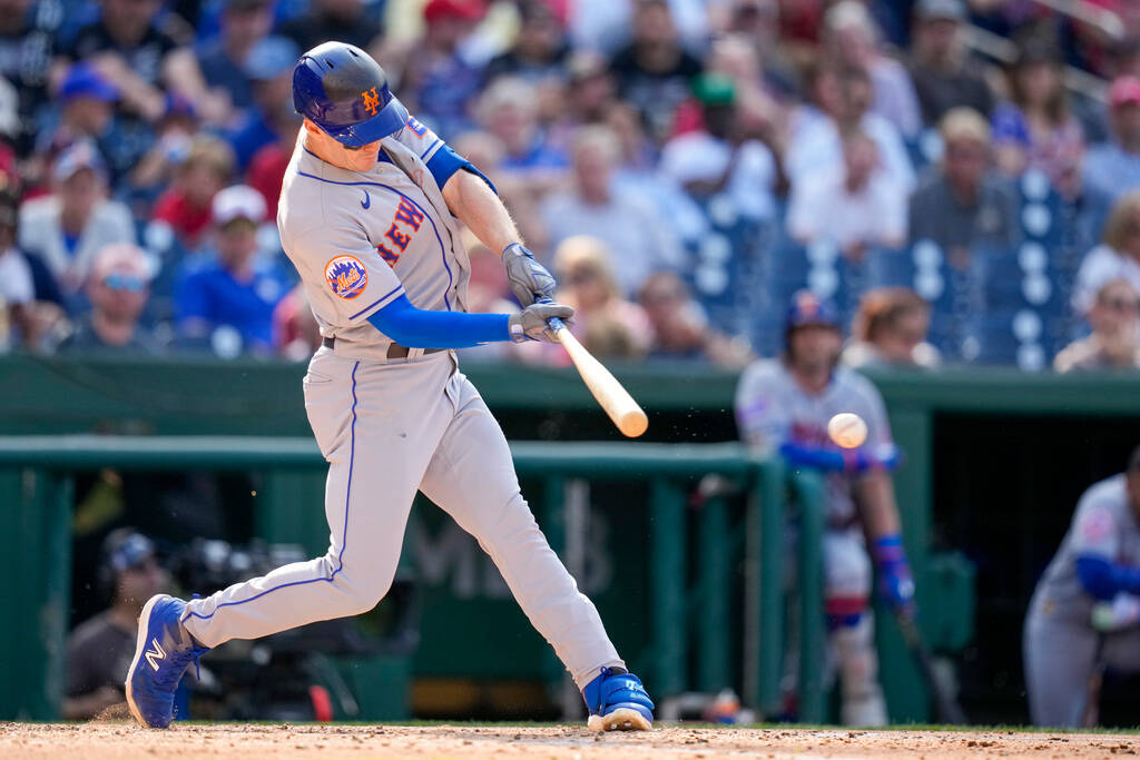 New York Mets' Mark Canha hits an RBI single during the fourth inning of a baseball game agains ...