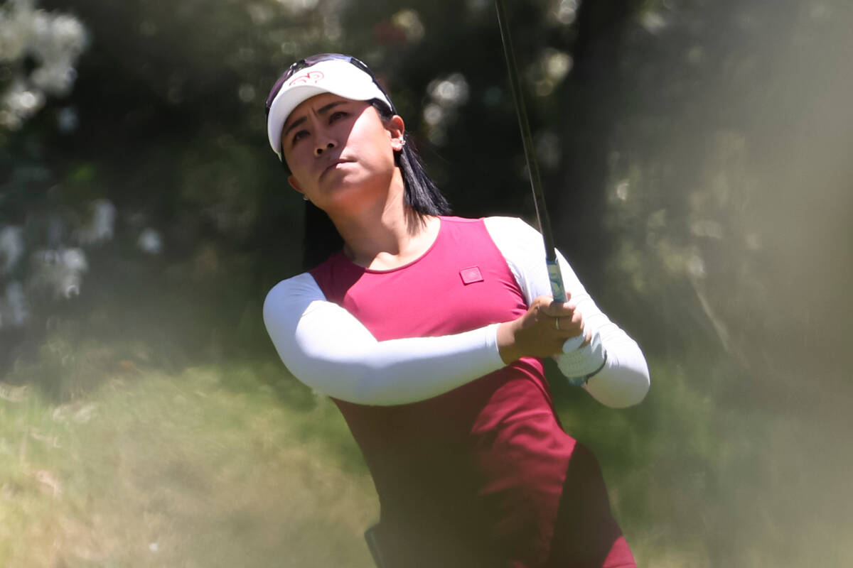 Danielle Kang tees off at the 12th hole while playing against Kelly Tan, not pictured, in the f ...