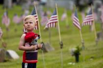Killian Carroll, 3, of Scranton, Pa. places his hat over his heart for the playing of the natio ...