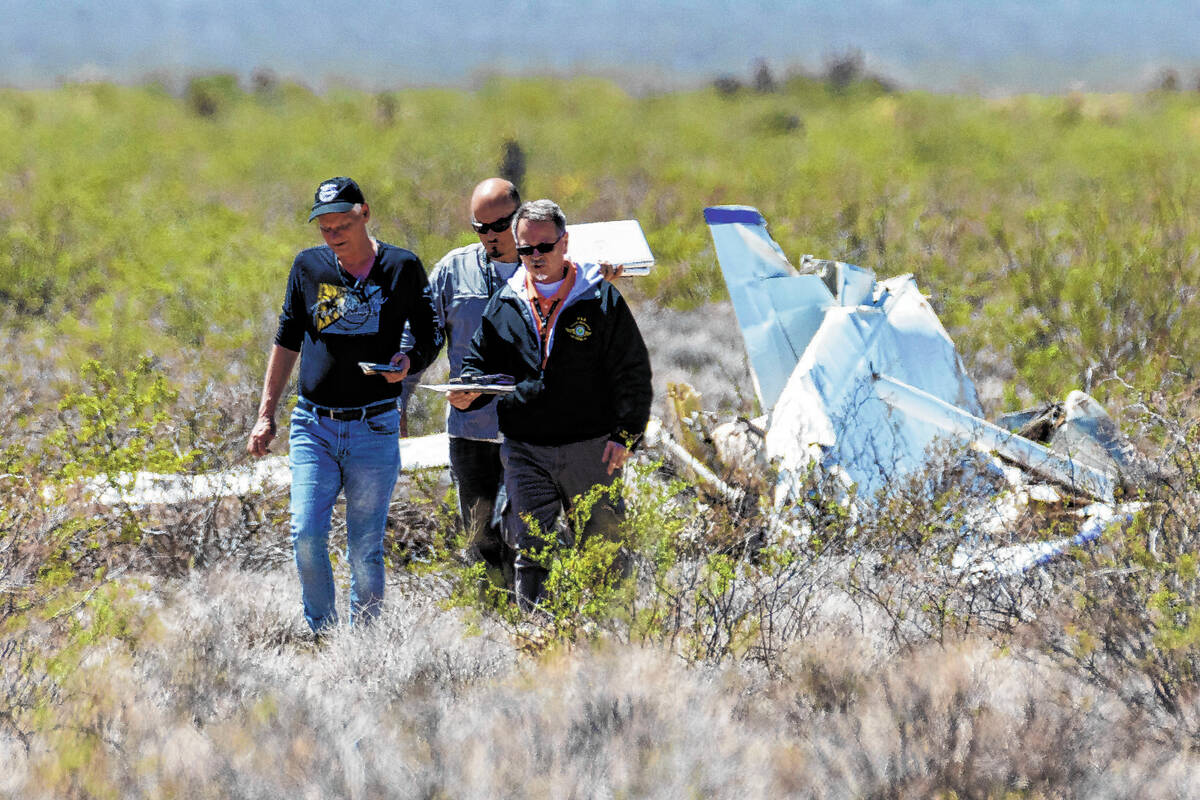 Officials from the FAA investigate a plane crash where two people died, on Tuesday, April 11, 2 ...