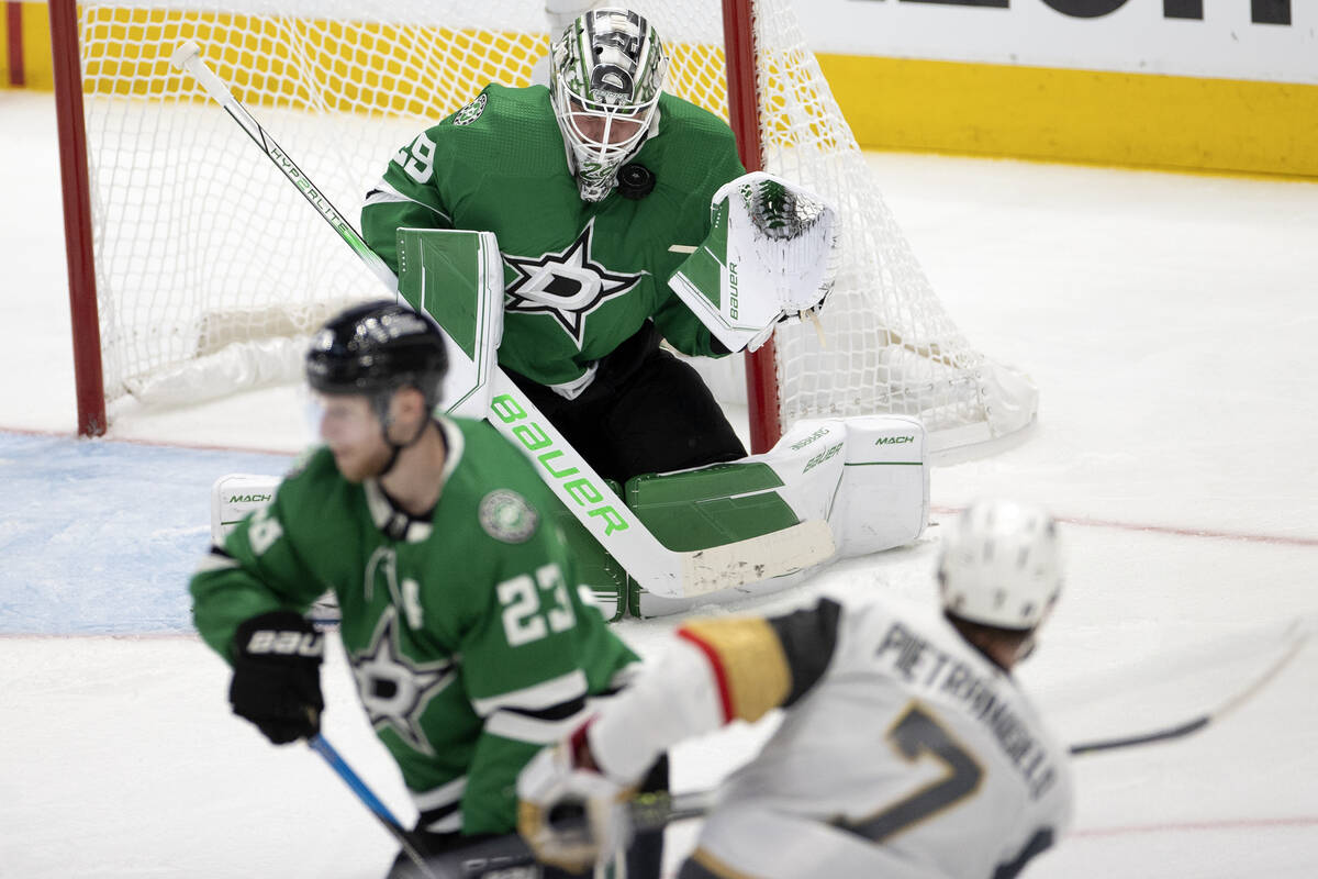 Dallas Stars goaltender Jake Oettinger (29) saves the puck from a shot by Golden Knights defens ...