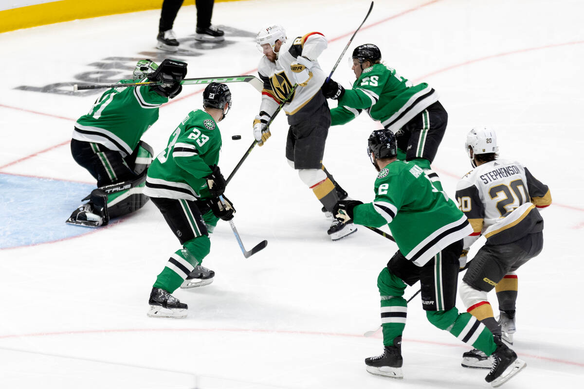 Golden Knights right wing Jonathan Marchessault (81) fights for the puck at the net against Dal ...