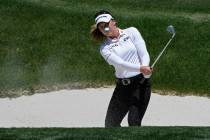 Brooke Henderson hits out of a bunker on the ninth green during the first day of round-robin pl ...