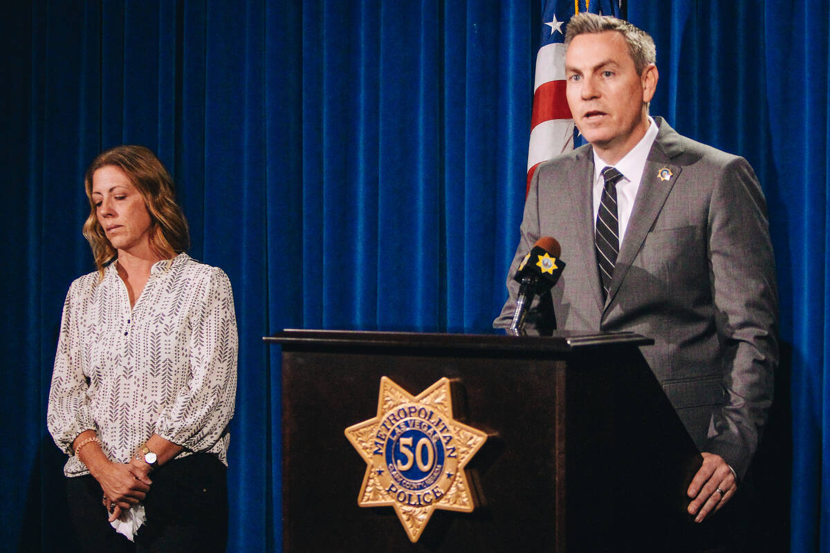 Shirl Huey, left, stands in silence as Lt. Jason Johansson asks the public for assistance in so ...