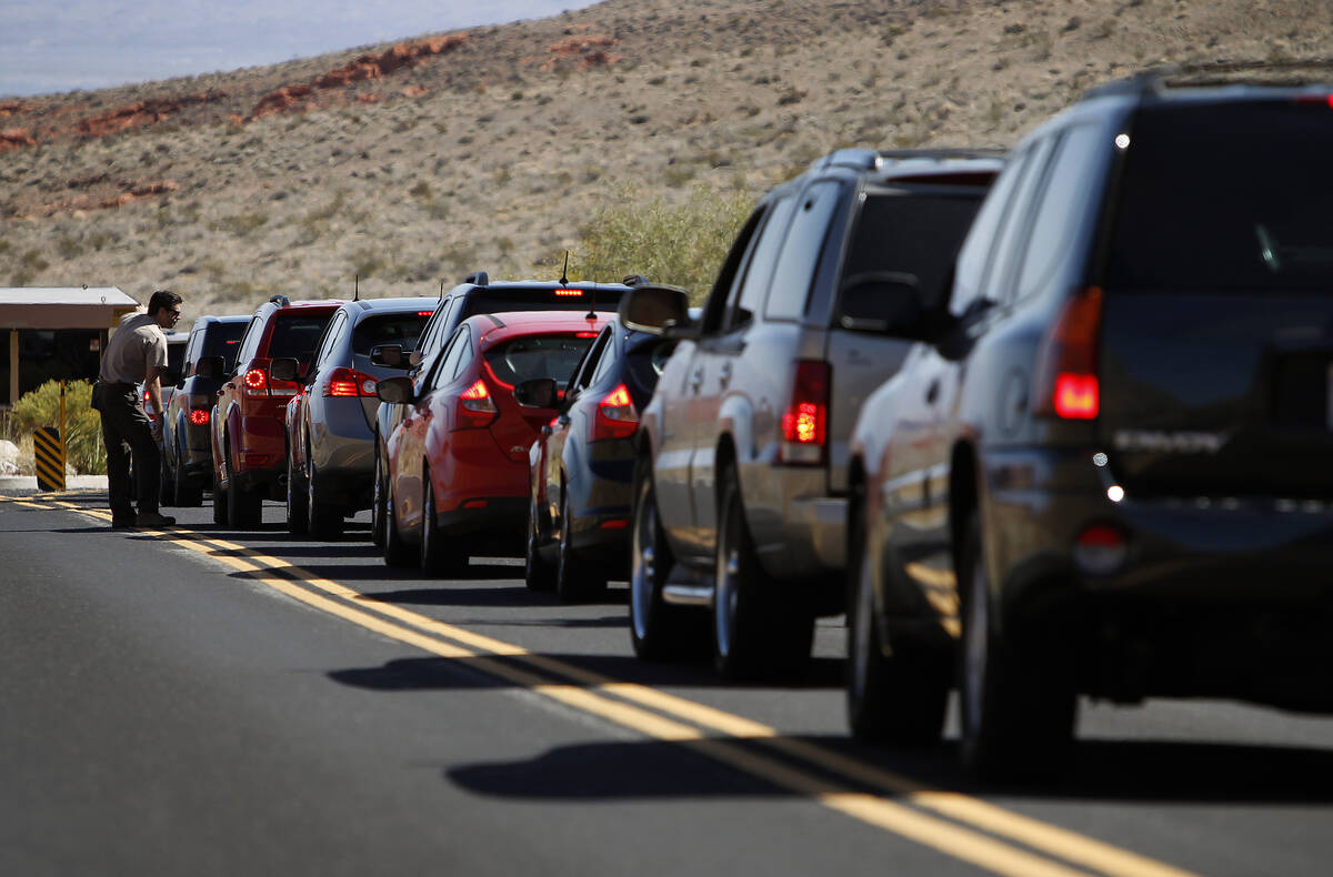 Park Ranger Chris Johnson speaks to visitors lined up at the entrance of Valley of Fire State P ...
