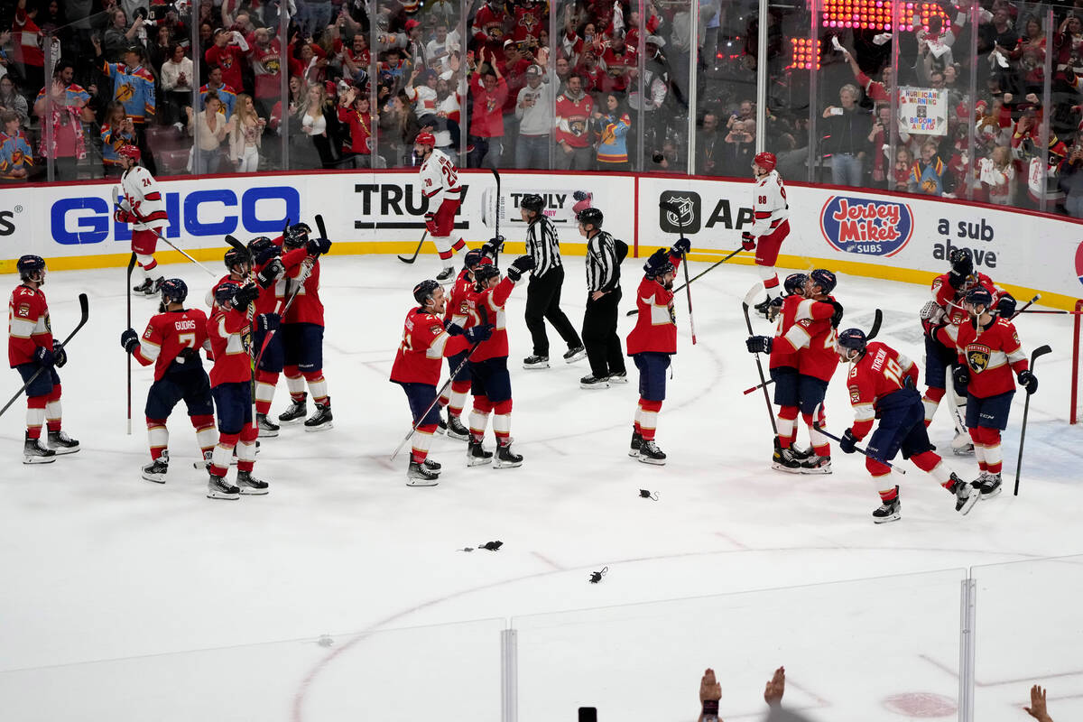 The Florida Panthers congratulate one another after defeating the Carolina Hurricanes in Game 4 ...